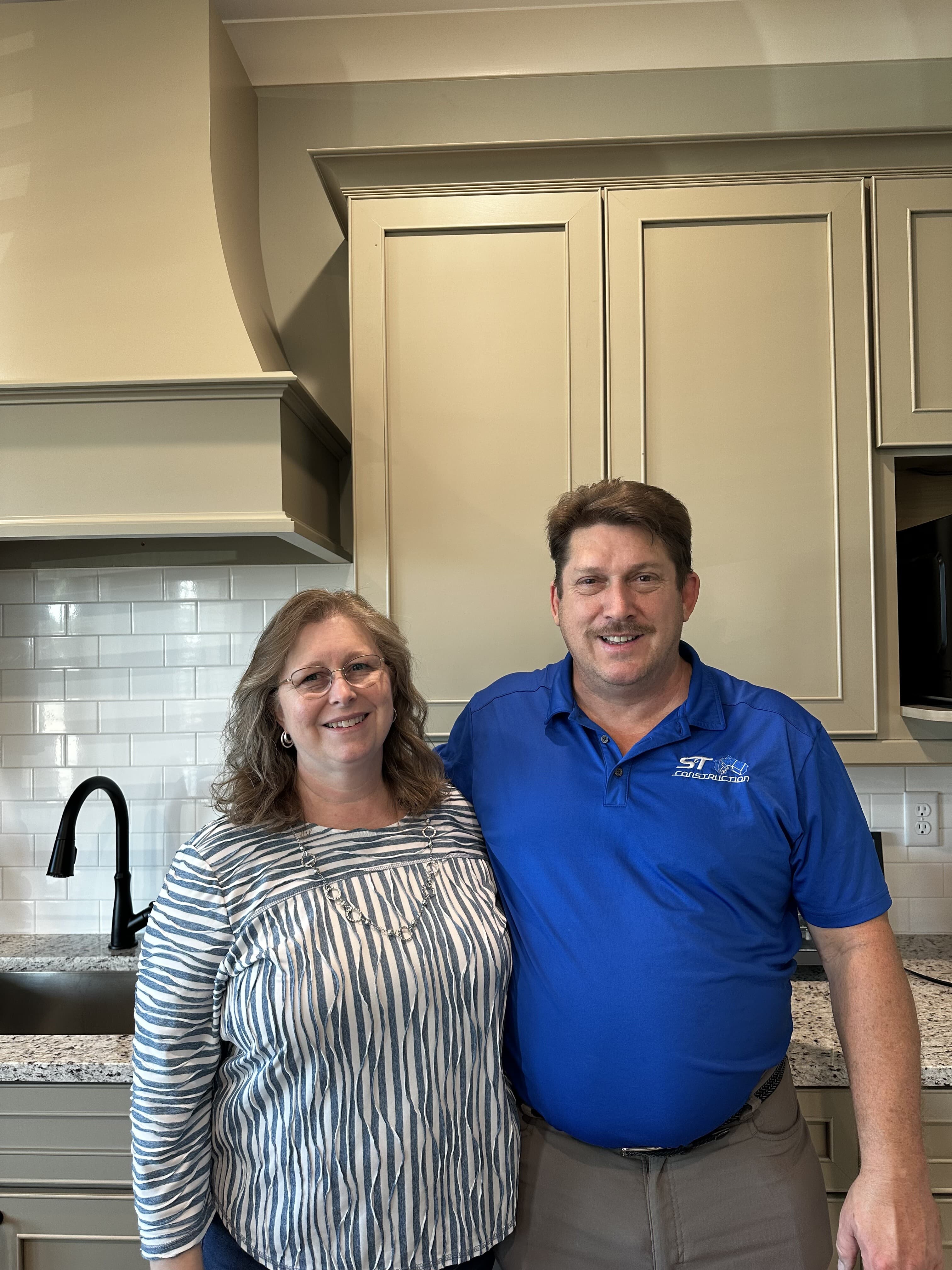 Scott and Tonya Conner, founders of S&T Construction, inside a finished custom home kitchen