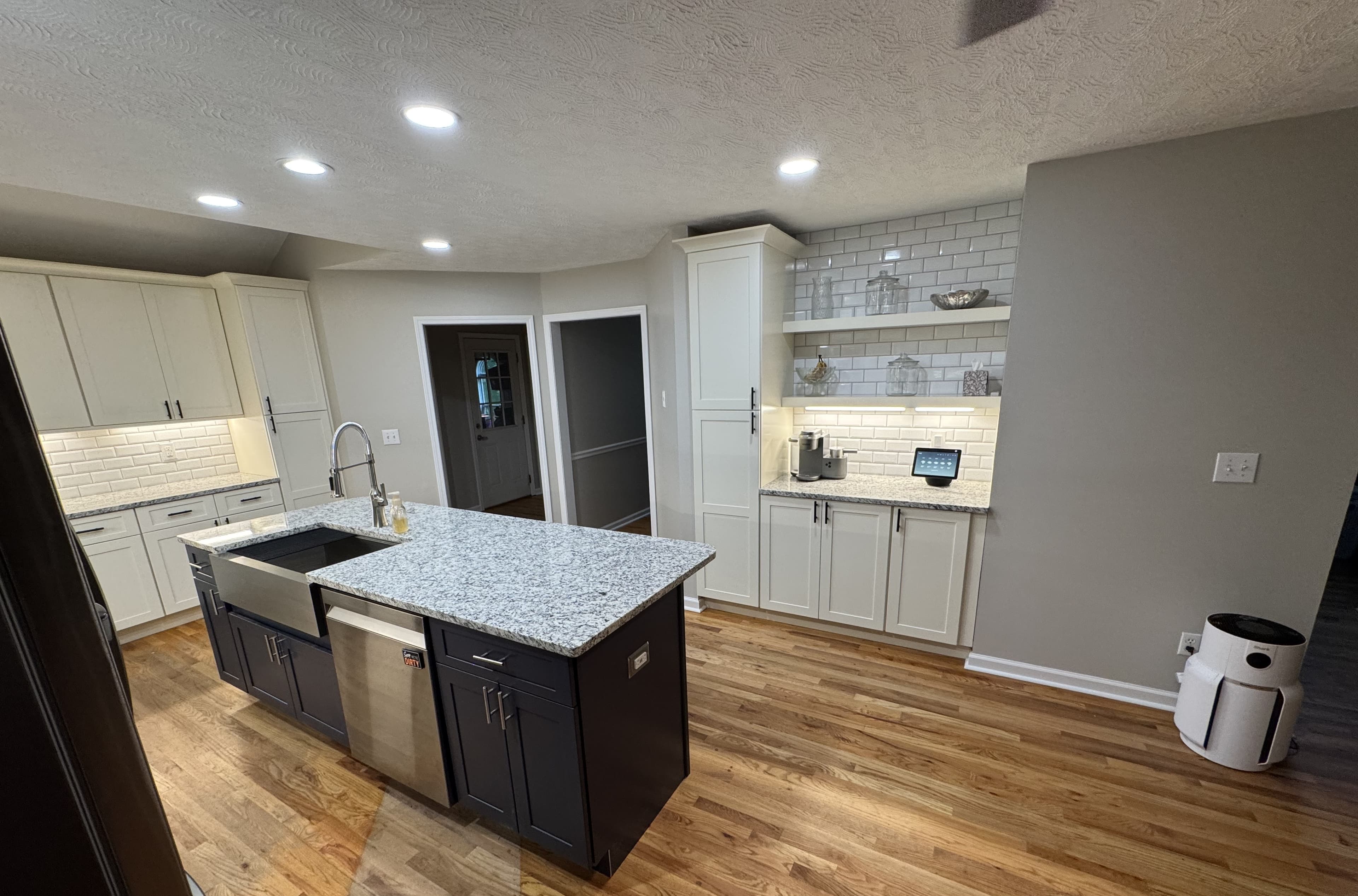 Finished kitchen with island sink and stainless appliances — S&T Construction remodel