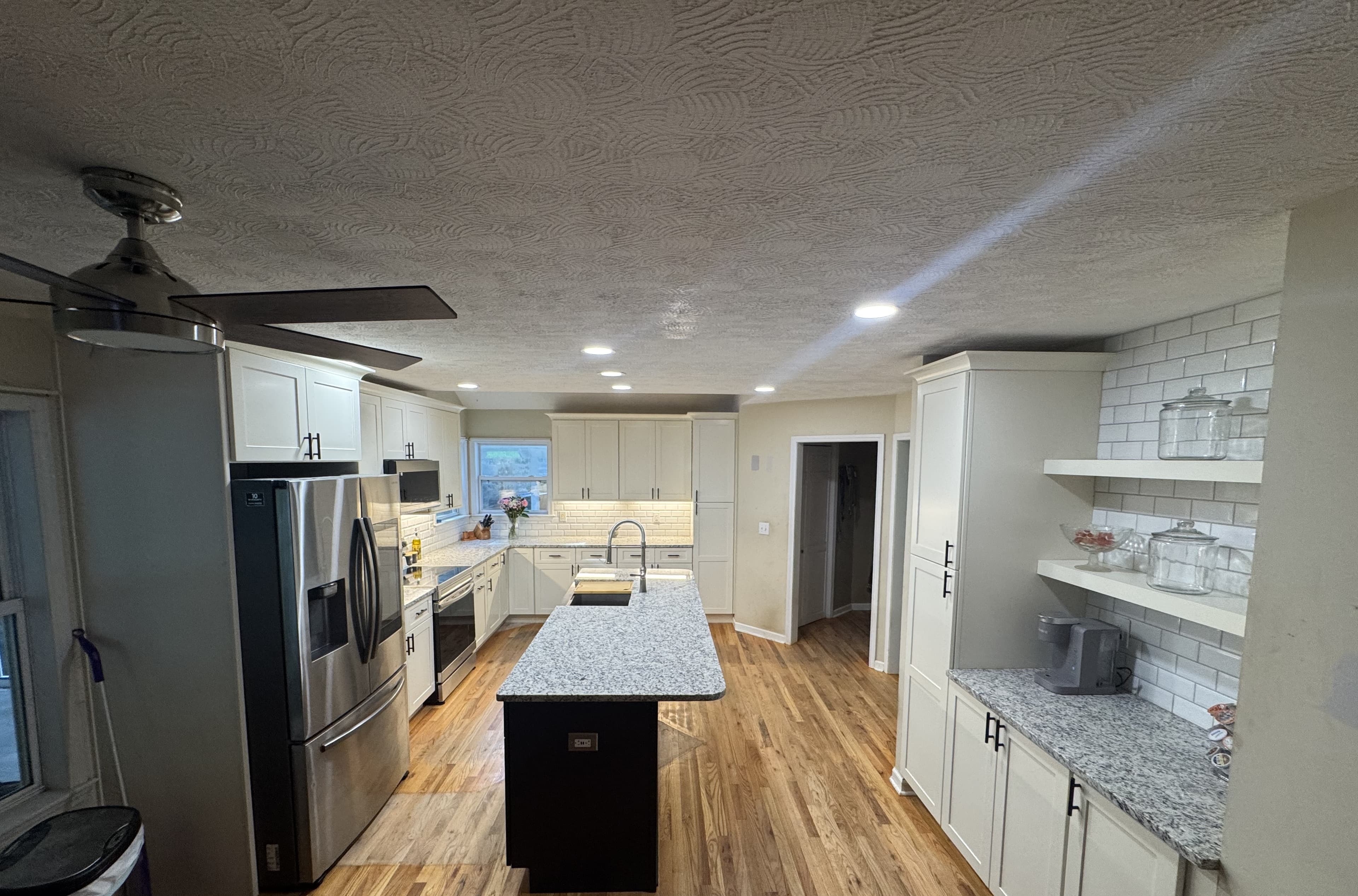 Full-width cabinetry with under-cabinet lighting — S&T Construction remodel