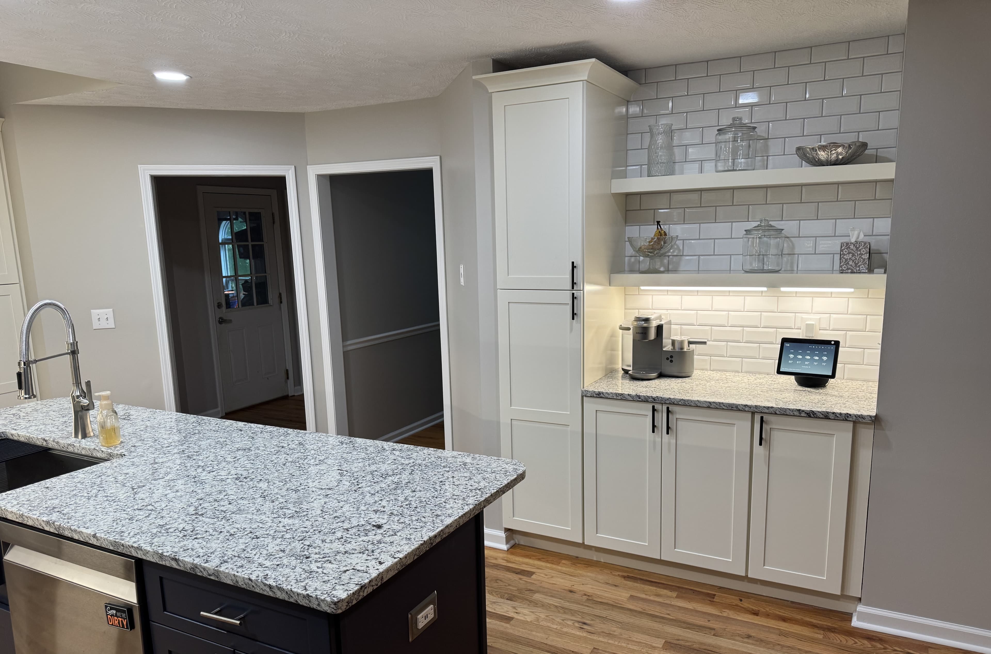 Granite island with farmhouse sink and bar seating — S&T Construction remodel