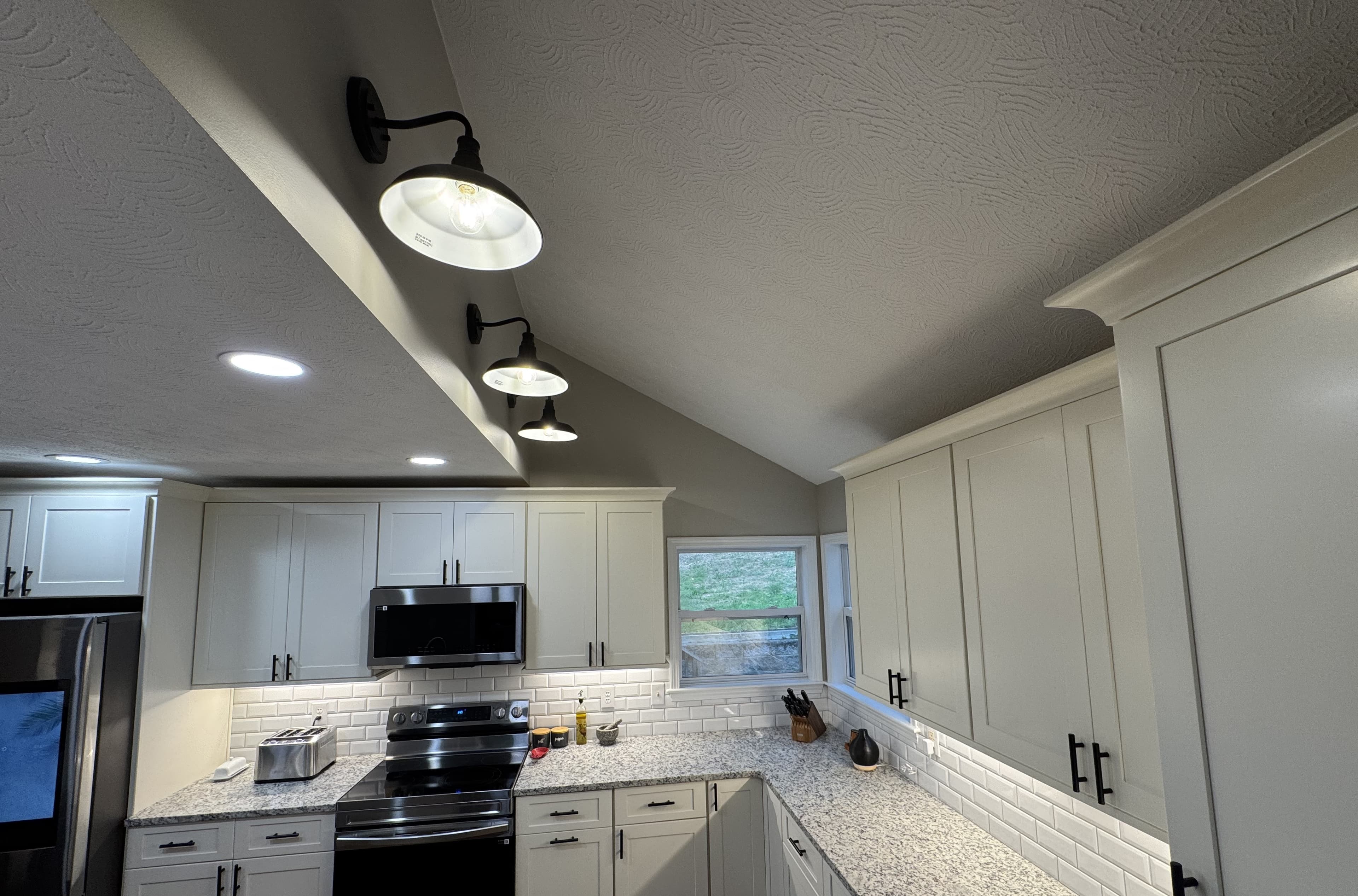 Vaulted ceiling with statement pendant lights — S&T Construction remodel