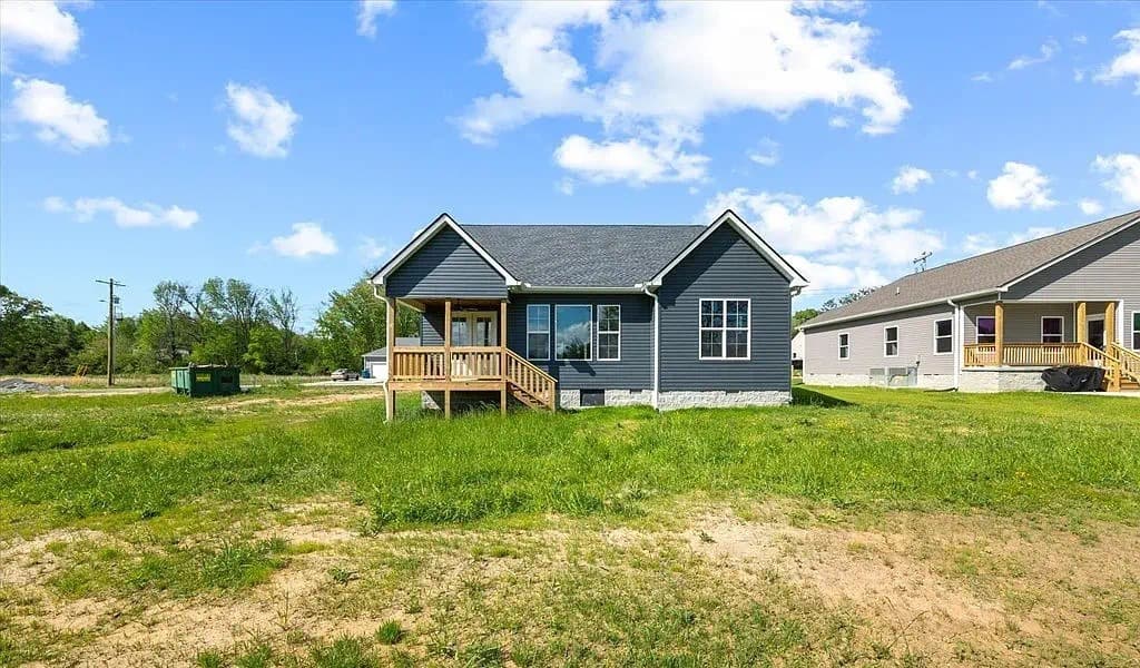 Rear exterior with deck and open yard — The Kaley by S&T Construction