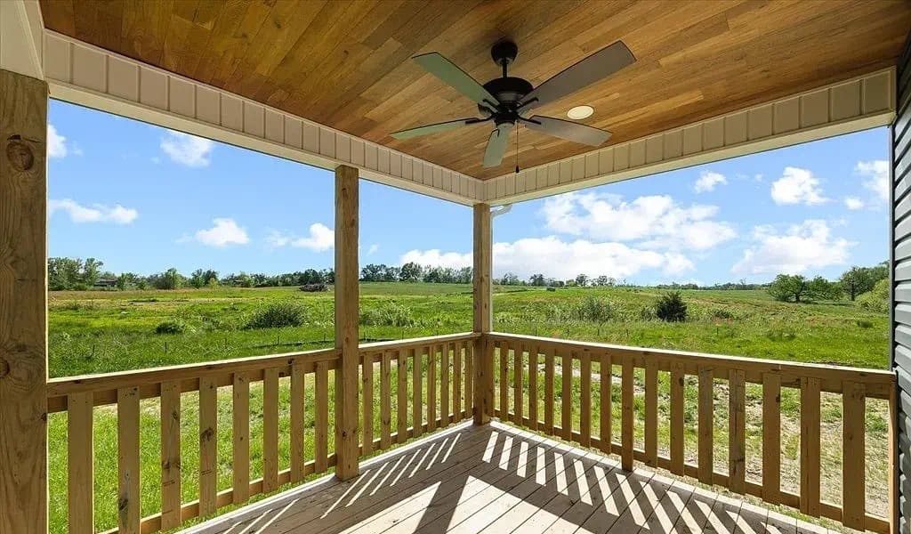 Covered back porch overlooking Tennessee farmland — The Kaley by S&T Construction