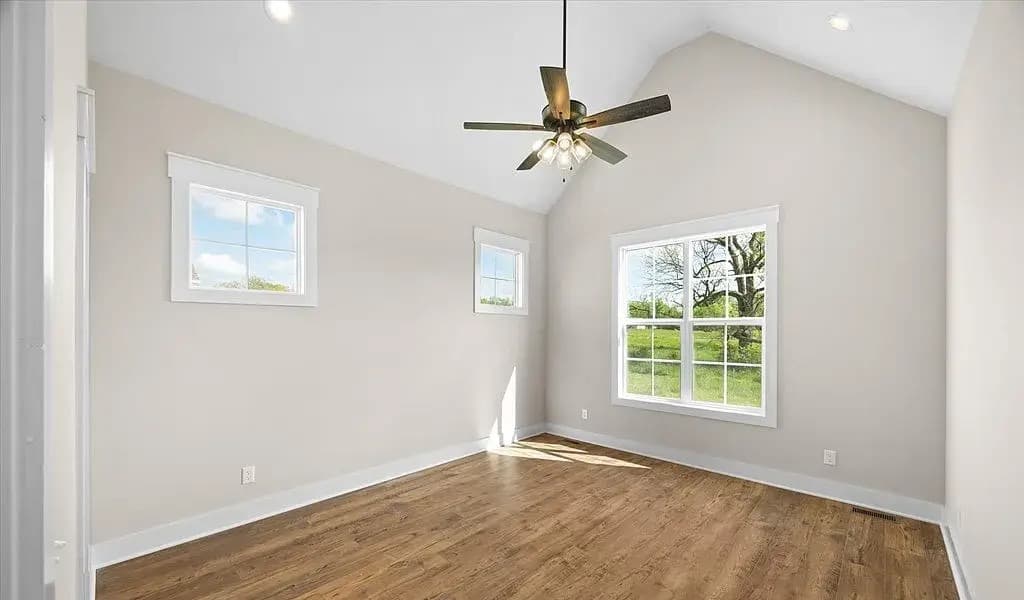 Master bedroom with vaulted ceiling and countryside views — The Kaley by S&T Construction