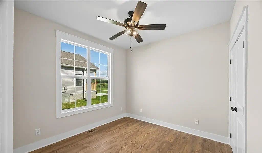 Bright bedroom with large windows — The Kaley by S&T Construction